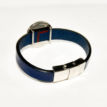 back view of a blue leather strap cuff bracelet with stainless steel slider charm and clasp