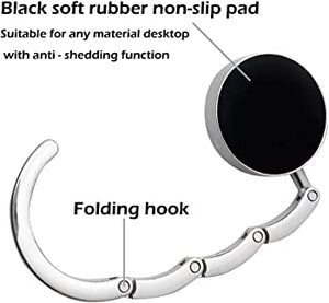 back view of a silver purse hook with black soft rubber non slip pad and folding hook