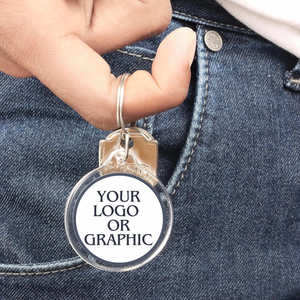 close up of someone holding an acrylic photo keychain on his finger