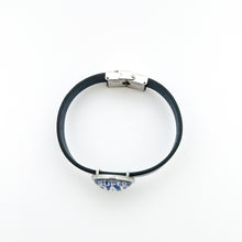 top view of blue leather cuff bracelet with closed stainless steel clasp