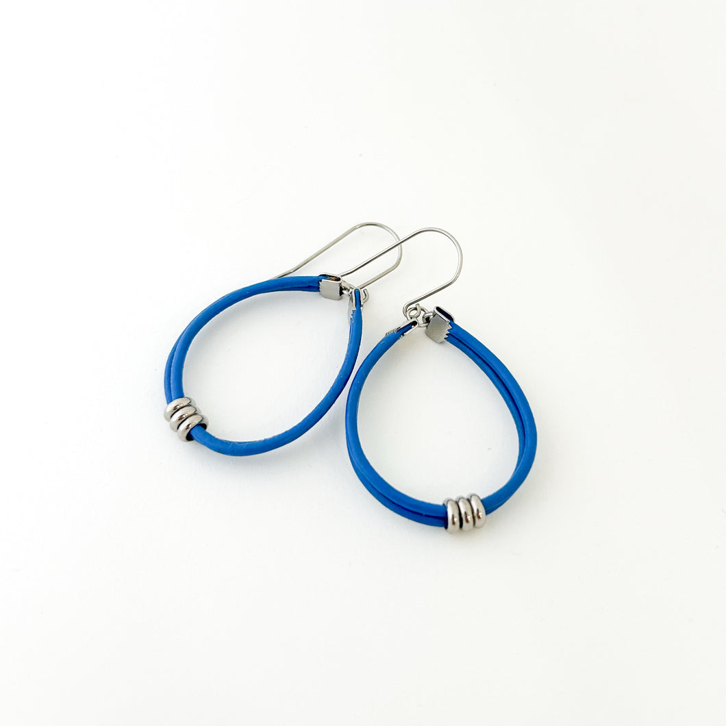 blue leather cord hoop earrings with stainless steel accents and titanium ear wires