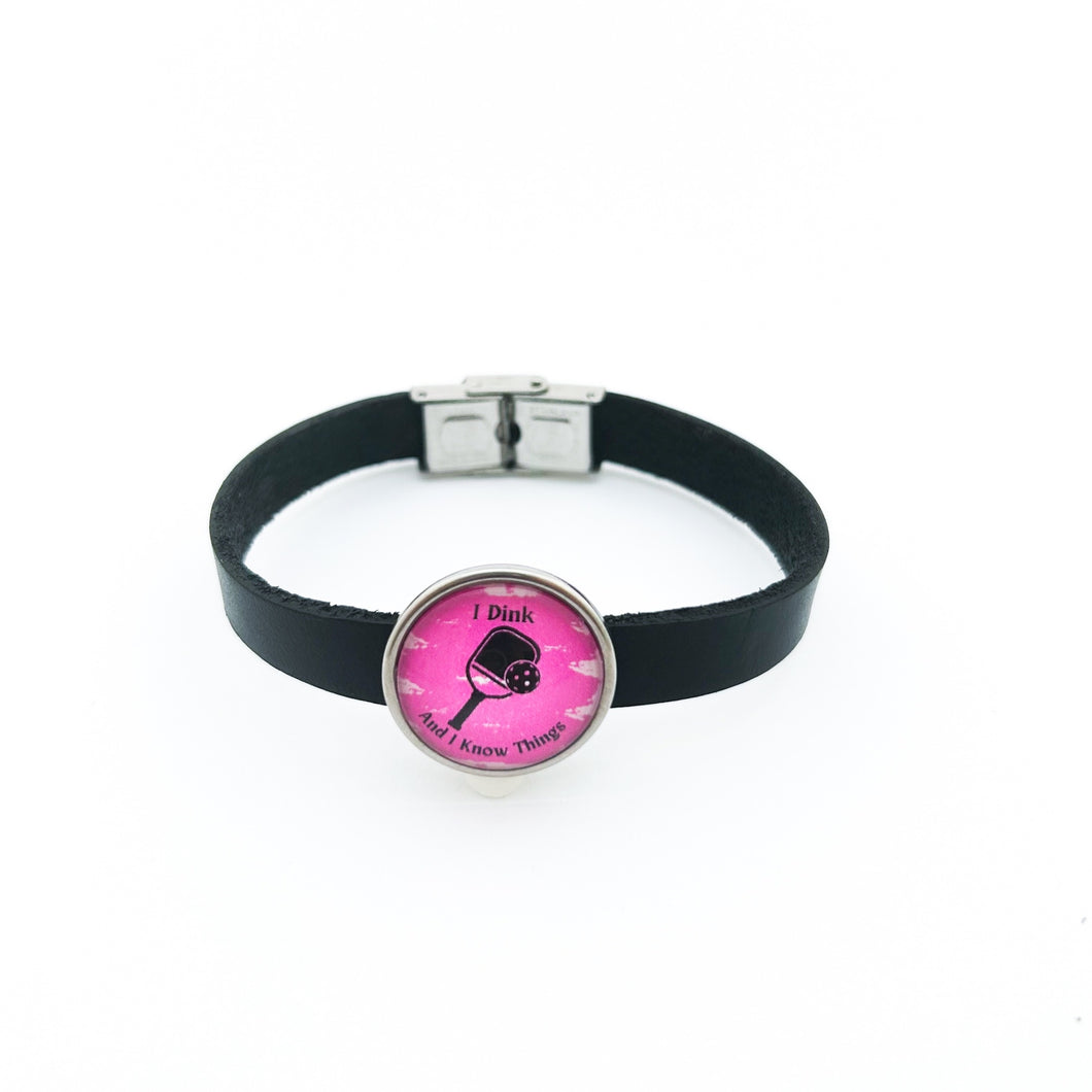 black leather cuff bracelet with stainless steel pickleball slide charm in pink I Dink graphic