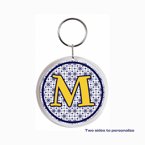 custom acrylic photo keychain featuring a gold initial M with navy blue pattern background