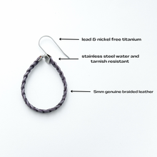 single purple braided leather hoop earrings on titanium ear wires with details listed in text