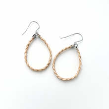 pair of metallic yellow braided leather hoop earrings on titanium ear wires