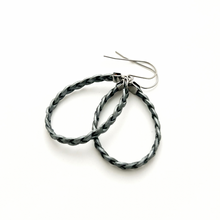 pair of gray braided leather hoop earrings on titanium ear wires