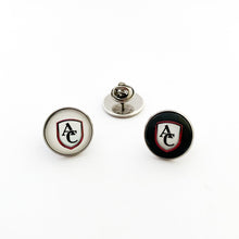Two stainless steel brooch pins with the Archbishop Curley high school logo, one with white background and one with black background