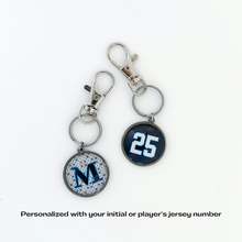 personalized stainless steel keychains with capital letter M and the number 25 in navy blue and white