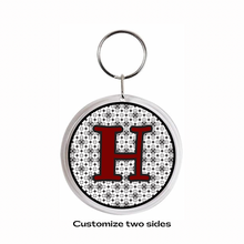 personalized acrylic keychain with maroon letter H and black pattern background
