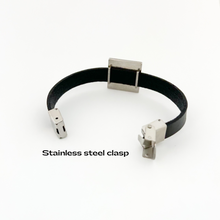 back view of black leather cuff bracelet with stainless steel square slide charm and opened stainless steel clasp
