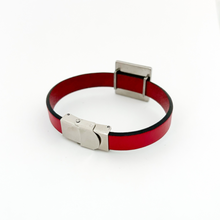 Red leather bracelet with silver clasp on a white background