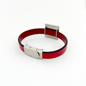 Red leather bracelet with silver clasp on a white background