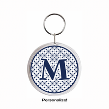 2.25" round acrylic Keychain with letter 'M' in navy blue on a navy blue and white patterned background