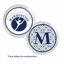 front and back view of a 2.25" round acrylic photo disc with 'Mckinney High School Marquettes' logo on one side and a large 'M' on the other both in navy blue and white