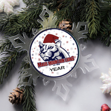 acrylic snowflake ornament with a Maus Mountain lions logo surrounded by Christmas pine branches and pinecones