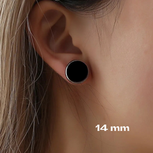 close up of white female wearing 14mm black stud earrings