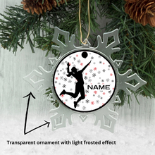 personalized ornament with a silhouette design of a volleyball player on a snowflakes background