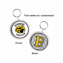 two round acrylic photo keychains with personalized Riverside Beavers logo on white  background and the other with a yellow B initial on a black patterned background