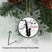 Transparent ornament with light frosted effect featuring a saxophone design and 'NAME' text, hanging on a Christmas tree.