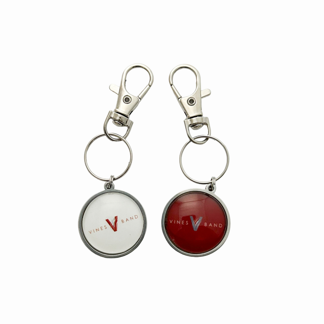two stainless steel circular keychains featuring the Vines High School Band logo in white and maroon with swivel clip attachment