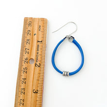 blue leather hoop earring with stainless steel accents and titanium ear wire measured with wooden ruler