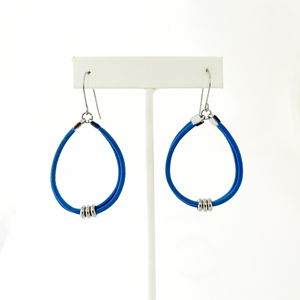 pair of blue leather cord hoop earrings hanging from titanium ear wires