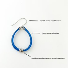 description of blue leather hoop earring with stainless steel accents and titanium ear wires
