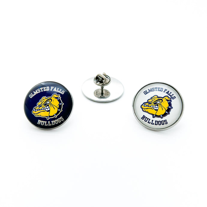pair of two stainless steel round brooch pins with the Olmsted Falls Bulldogs logos one with blue background and one with white background