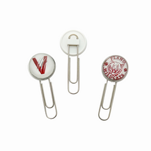 Two paper clips with circular ends featuring the vines v logo and the plano senior wildcats logo in maroon and white