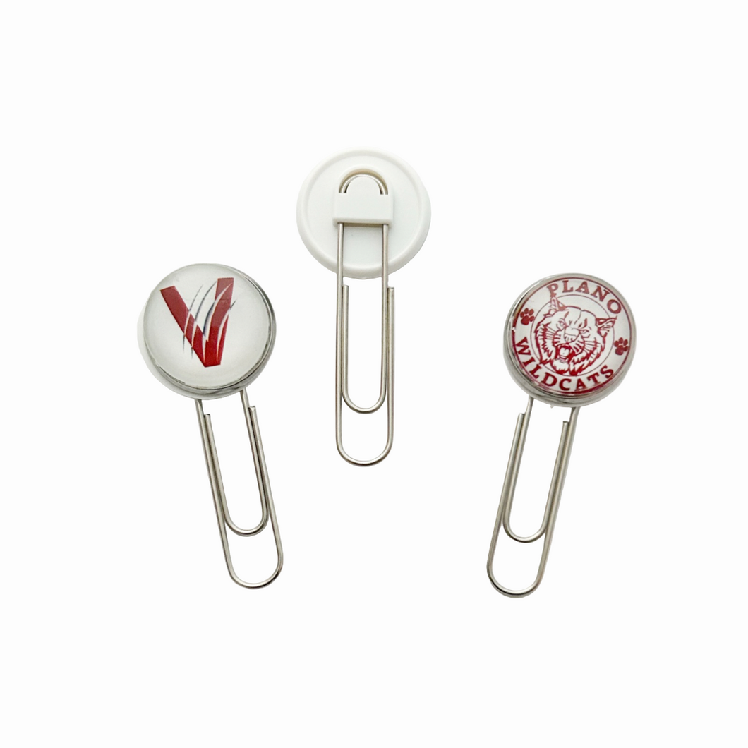 Two paper clips with circular ends featuring the vines v logo and the plano senior wildcats logo in maroon and white