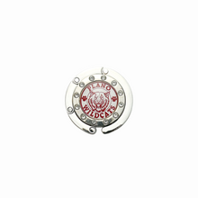 silver circular purse hook surrounded with clear rhinestones and a cabochon charm featuring the Plano Senior high school wildcats logo
