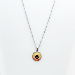 stainless steel pickleball necklace with yellow and orange rise and shine grahpic
