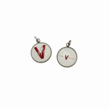 set of two stainless steel circular charms one with the vines v logo and the other with the vines band logo
