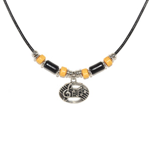 silver musical pendant necklace with black and yellow beads