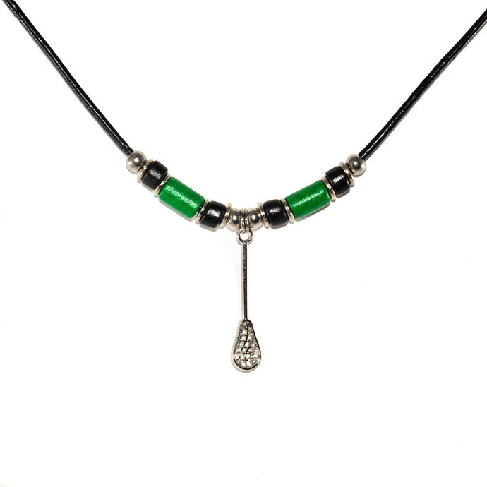 silver lacrosse stick charm necklace with green and black beads on a black leather cord