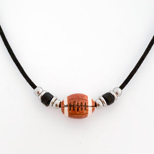 ceramic football bead necklace with black tube bead and stainless steel spacer beads accents strung on a black cotton cord