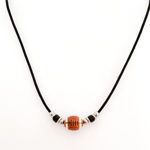 ceramic football bead necklace with black tube bead and stainless steel spacer beads accents strung on a black cotton cord