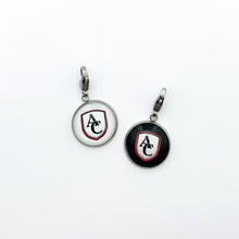 Two stainless steel zipper pulls with a round design featuring the the Archbishop Curley high school logo, one with white background and one with black background