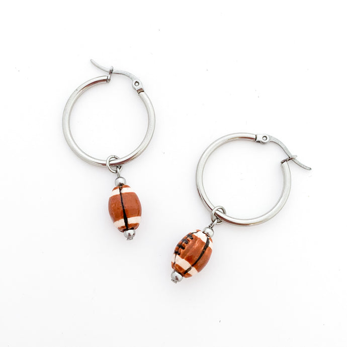 stainless steel hoop earrings with ceramic football bead charm drops