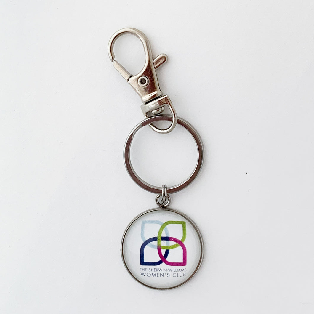 stainless steel keychain with white Sherwin Williams Women's Club logo