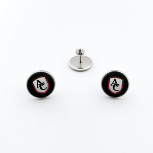 Stainless steel round stud earrings with custom Archbishop Curley high school logo cabochon on a black
 background.