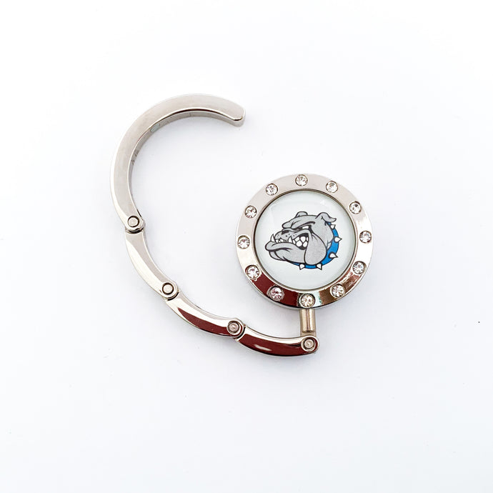 silver circular purse hook surrounded by clear rhinestones with a Belgreen Bulldogs graphic in the center