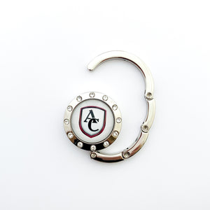 custom silver purse and bag hook with rhinestone border featuring the Archbishop Curley high school logo