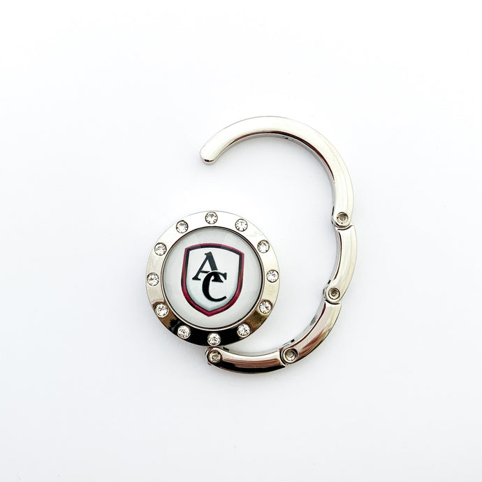 custom silver purse and bag hook with rhinestone border featuring the Archbishop Curley high school logo