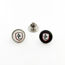 two custom stainless steel lapel pins with the Archbishop Curley high school logo, one in white and one in black