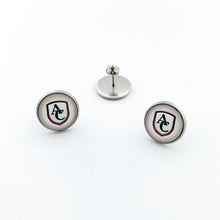 Stainless steel round stud earrings with custom Archbishop Curley high school logo cabochon on a white background.