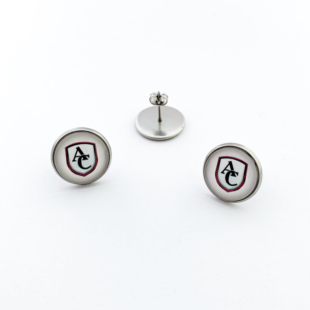 Stainless steel round stud earrings with custom Archbishop Curley high school logo cabochon on a white background.