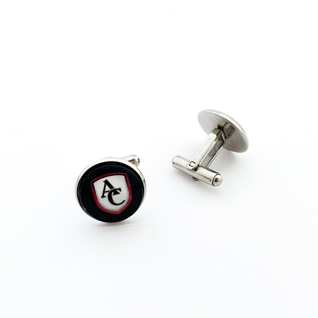 custom stainless steel round cufflinks with the Archbishop Curley high school logo in black