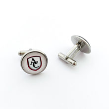 custom stainless steel round cuff links with the Archbishop Curley high school logo in white