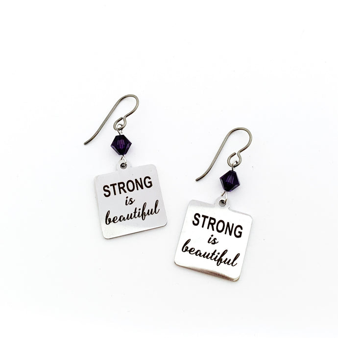 stainless steel charm earrings with laser engraved with Strong is Beautiful accented with 6 mm purple Swarovski crystal bicone beads